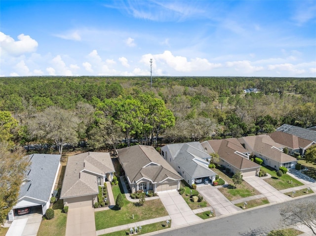 birds eye view of property featuring a residential view and a view of trees