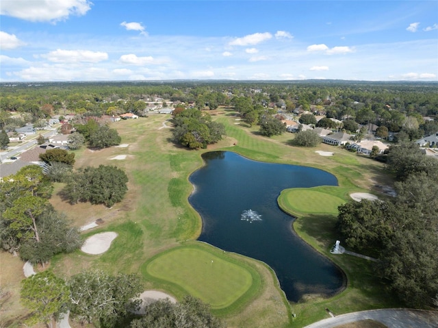 drone / aerial view with view of golf course and a water view