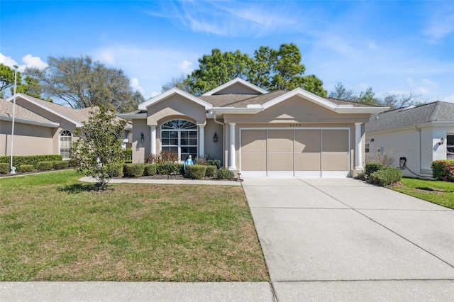 single story home with stucco siding, an attached garage, concrete driveway, and a front lawn