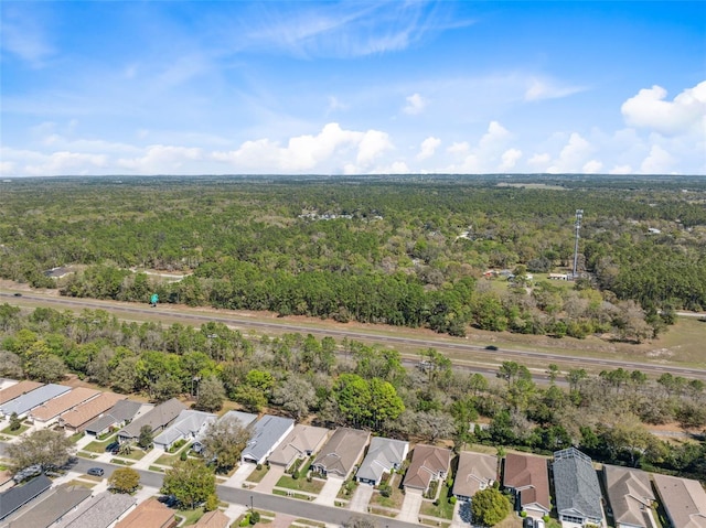 bird's eye view featuring a forest view and a residential view
