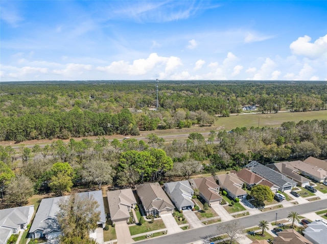 birds eye view of property featuring a view of trees and a residential view
