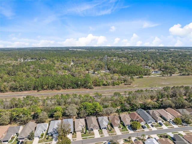 birds eye view of property with a forest view and a residential view