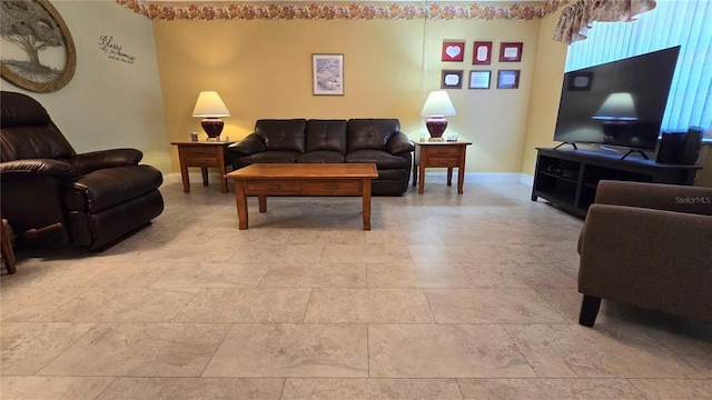 living area featuring baseboards