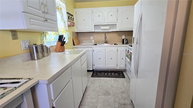 kitchen featuring white cabinetry, white appliances, light countertops, and a sink