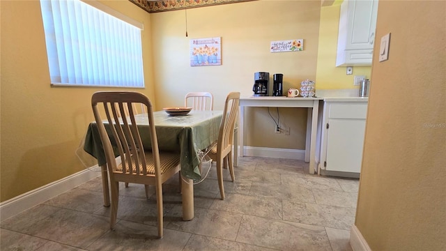 dining area featuring baseboards