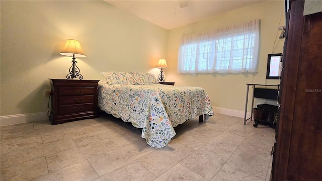 bedroom featuring vaulted ceiling and baseboards