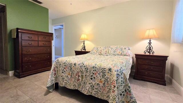 bedroom with visible vents and baseboards