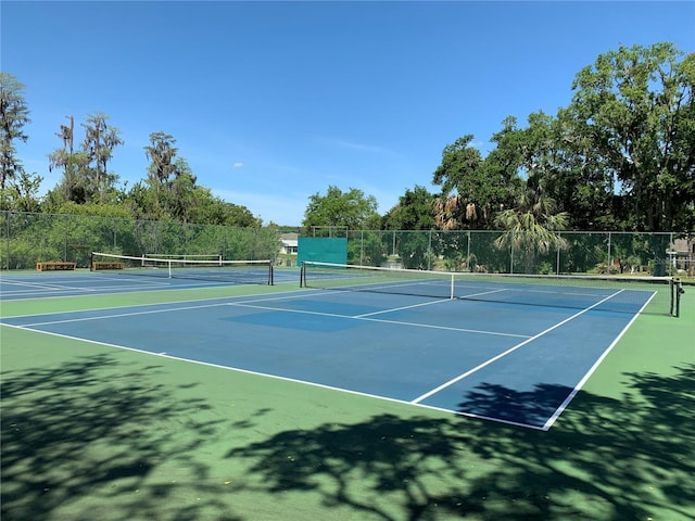 view of tennis court with fence