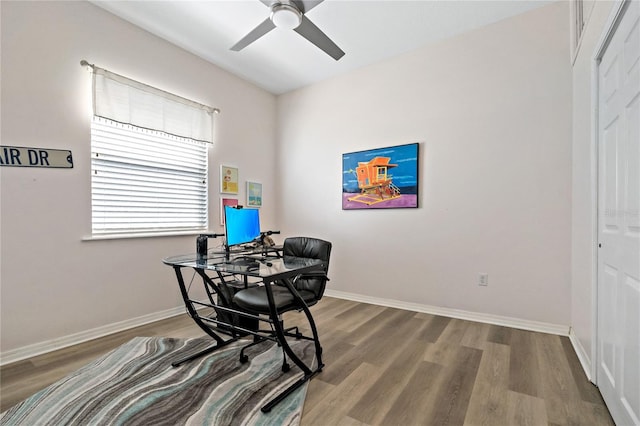 home office with baseboards, wood finished floors, and ceiling fan