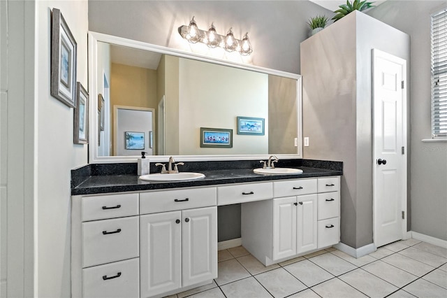 bathroom with double vanity, tile patterned floors, and a sink