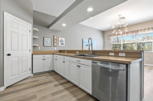 kitchen featuring visible vents, light wood-type flooring, a sink, stainless steel dishwasher, and a chandelier