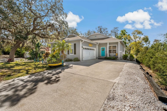 view of front of home featuring an attached garage, driveway, and roof with shingles