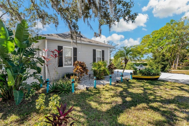 view of property exterior with a yard