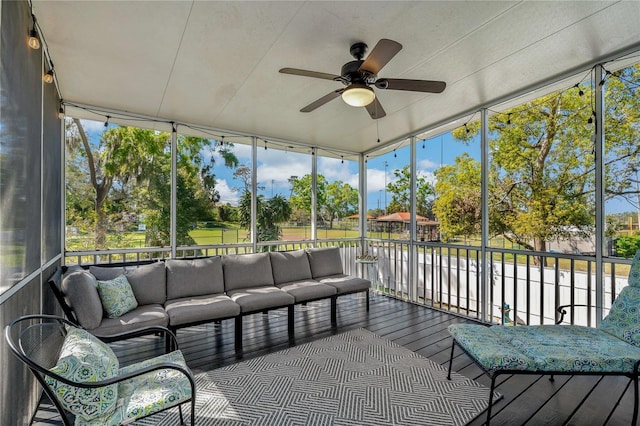 sunroom featuring a ceiling fan