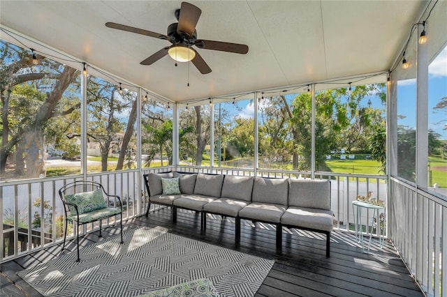 unfurnished sunroom featuring ceiling fan