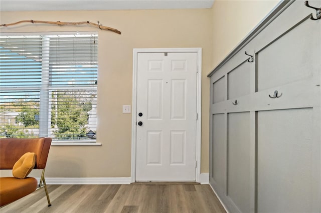 foyer with light wood-type flooring and baseboards