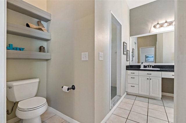 full bath featuring vanity, walk in shower, baseboards, toilet, and tile patterned flooring