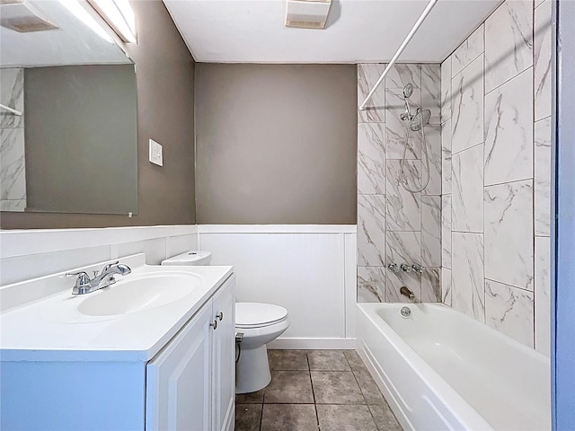 full bathroom featuring vanity,  shower combination, tile patterned flooring, wainscoting, and toilet