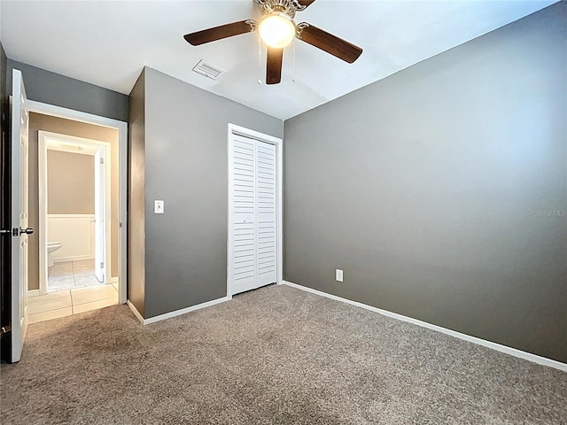 unfurnished bedroom with visible vents, a ceiling fan, a closet, carpet flooring, and baseboards