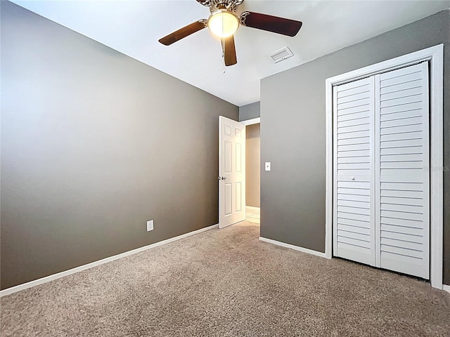 unfurnished bedroom with visible vents, ceiling fan, baseboards, carpet floors, and a closet