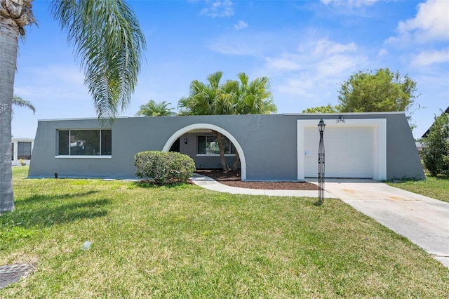 view of front of house with stucco siding, a garage, concrete driveway, and a front yard