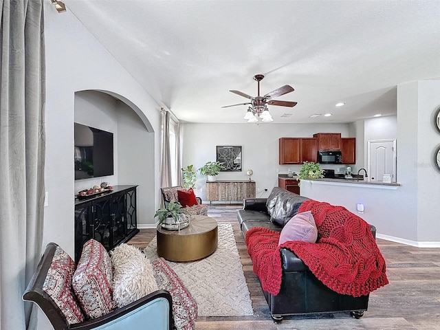 living area featuring a ceiling fan, recessed lighting, wood finished floors, and baseboards