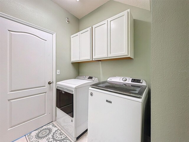 laundry area with washer and clothes dryer and cabinet space