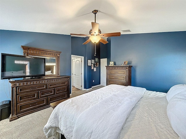 bedroom with visible vents, a ceiling fan, carpet, and lofted ceiling