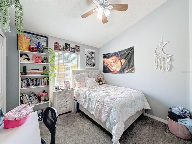 bedroom with a ceiling fan, baseboards, carpet floors, vaulted ceiling, and a textured ceiling