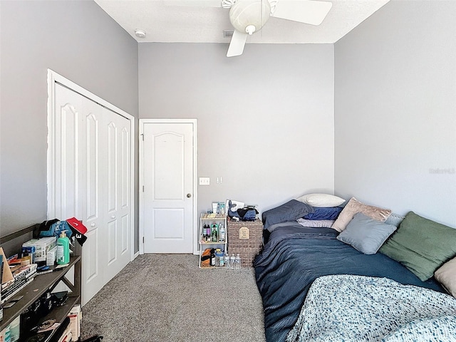 carpeted bedroom with a closet and a ceiling fan