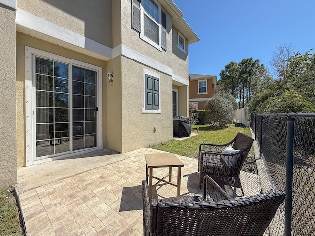 view of patio / terrace with a fenced backyard and a grill