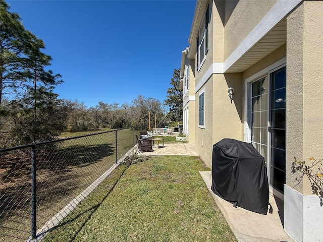 view of yard featuring a patio area and a fenced backyard