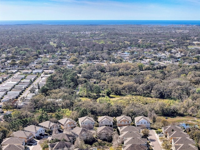 aerial view featuring a residential view and a wooded view