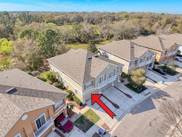 birds eye view of property with a wooded view