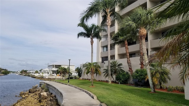 view of home's community with a yard and a water view