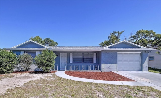 ranch-style home featuring brick siding, an attached garage, a porch, and concrete driveway