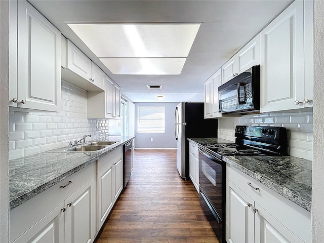 kitchen with visible vents, dark wood-type flooring, black appliances, a sink, and white cabinetry