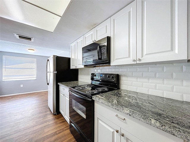 kitchen featuring visible vents, light wood-style flooring, decorative backsplash, black appliances, and white cabinets