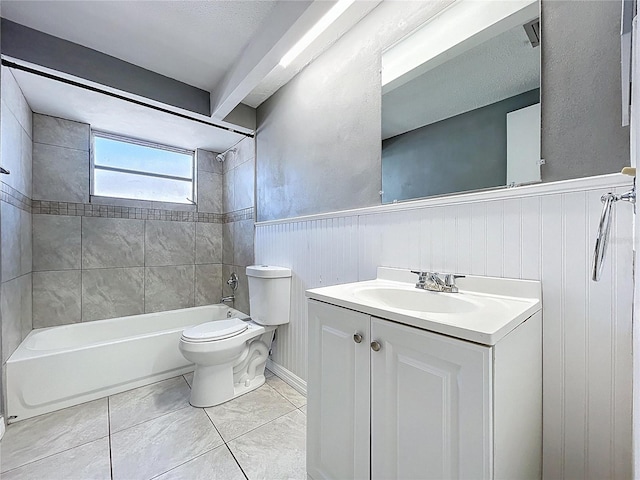 bathroom featuring washtub / shower combination, a wainscoted wall, toilet, and vanity