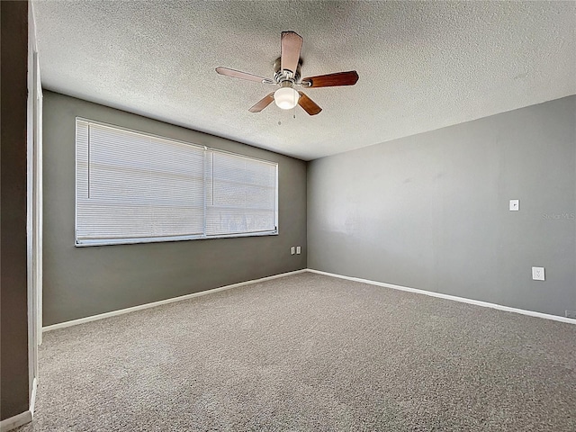 unfurnished room featuring a textured ceiling, carpet flooring, baseboards, and ceiling fan