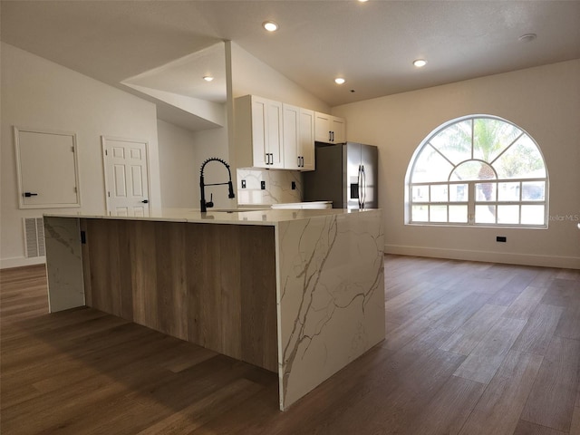 1032 Concert Ave, Spring Hill, FL 34609 - kitchen featuring visible vents, a sink, white cabinets, stainless steel fridge with ice dispenser, and vaulted ceiling