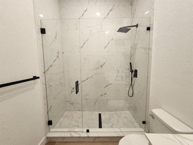 1032 Concert Ave, Spring Hill, FL 34609 - bathroom featuring toilet, a textured wall, and a marble finish shower