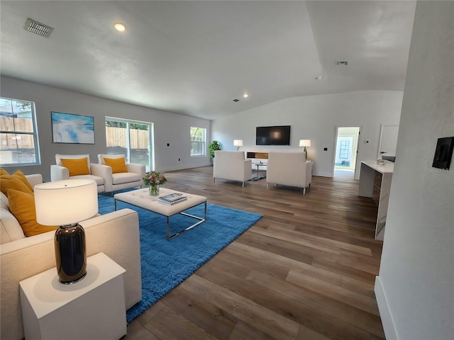 1032 Concert Ave, Spring Hill, FL 34609 - living room featuring visible vents, lofted ceiling, baseboards, and wood finished floors