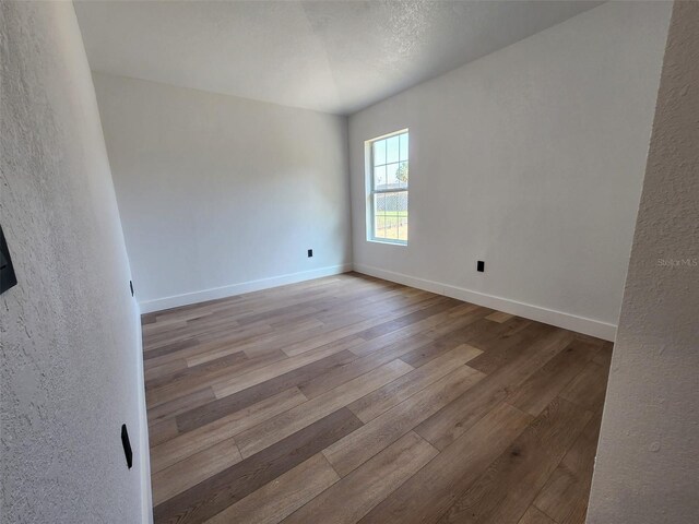 1032 Concert Ave, Spring Hill, FL 34609 - spare room featuring baseboards and wood finished floors