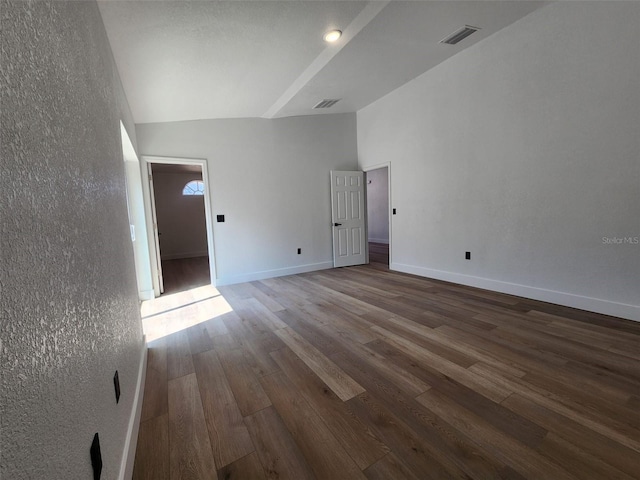 1032 Concert Ave, Spring Hill, FL 34609 - unfurnished room featuring wood finished floors, visible vents, baseboards, vaulted ceiling, and a textured wall