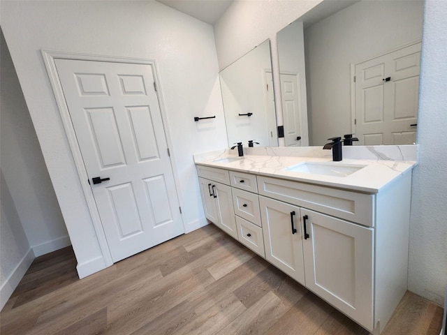 1032 Concert Ave, Spring Hill, FL 34609 - bathroom with double vanity, wood finished floors, baseboards, and a sink