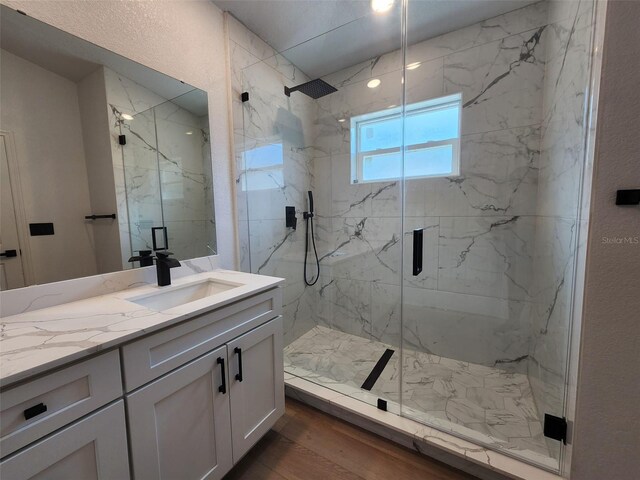 1032 Concert Ave, Spring Hill, FL 34609 - full bathroom with vanity, a textured wall, wood finished floors, and a marble finish shower