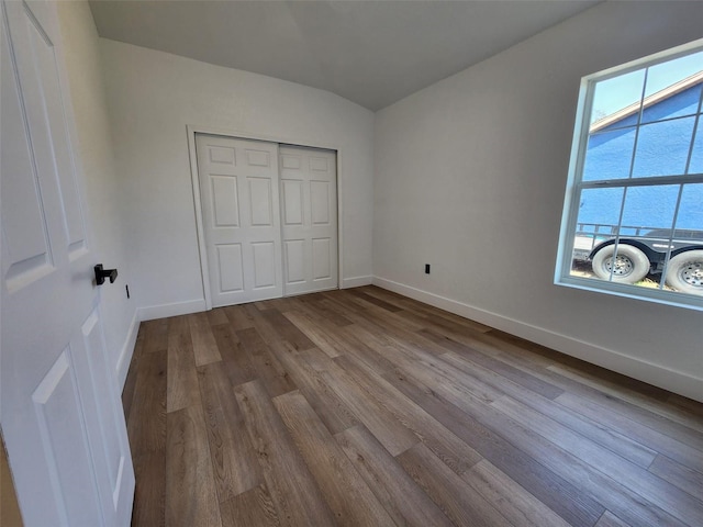 1032 Concert Ave, Spring Hill, FL 34609 - unfurnished bedroom featuring wood finished floors, baseboards, and a closet
