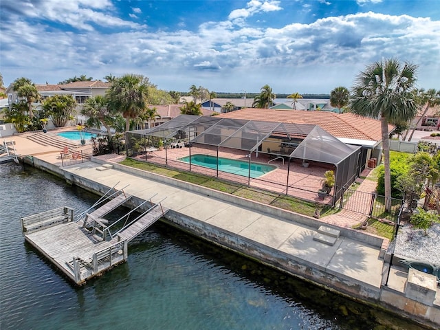 exterior space featuring a patio, fence, a fenced in pool, a water view, and a lanai