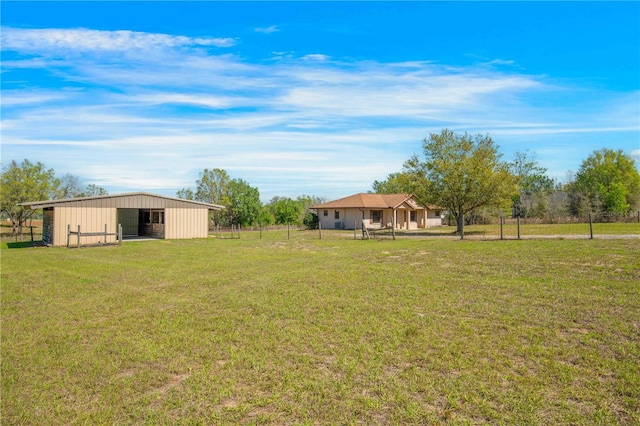 view of yard featuring a detached garage, an outbuilding, and an outdoor structure